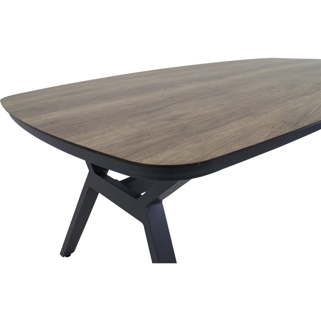 Ovale tafel met donker houtnerf blad en zwartgrijs frame met gebogen poot