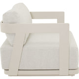 Fauteuil met lichtbeige bekleding, witte zijpanelen en afgeronde armleuning
