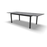 Uittrektafel in uitgeschoven stand, betonkleurig blad en donkere poten