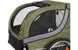 Groene fietskar met gebogen zijpanelen en mesh raampartijen, zwarte rand