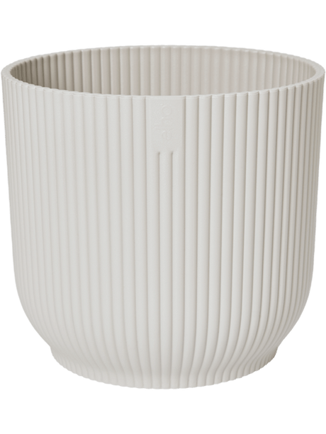 Witte ronde plantenpot met verticale ribbels en opstaande rand