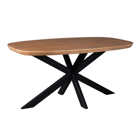 Ovale eettafel met naturel houten blad en zwart kruisvormig onderstel.