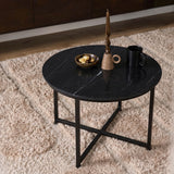 Ronde salontafel met zwart gemarmerd blad en zwart metalen poten, decor op het blad.