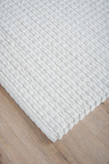Vloerkleed Nicole crème: close-up van geribbelde, lichtcrème pool en rand