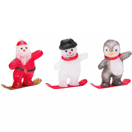 Assorti kerstfiguren op snowboard: rode kerstman, witte sneeuwpop en grijze pinguïn